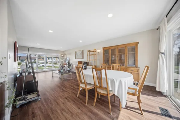 a view of a dining room with furniture window and wooden floor
