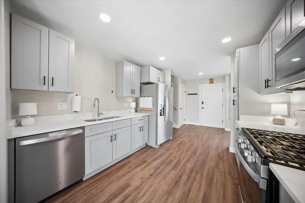 a kitchen with a sink stove and refrigerator