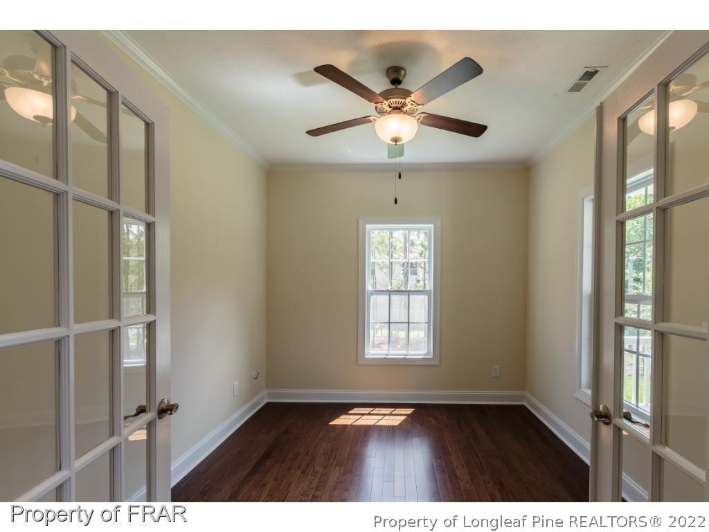 210 Dicks Hill Road Carthage, NC 28327 - Photo 17 of 29 a view of an empty room with a window and wooden floor