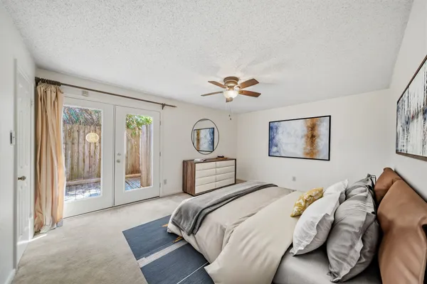 a bedroom with a bed and a chandelier