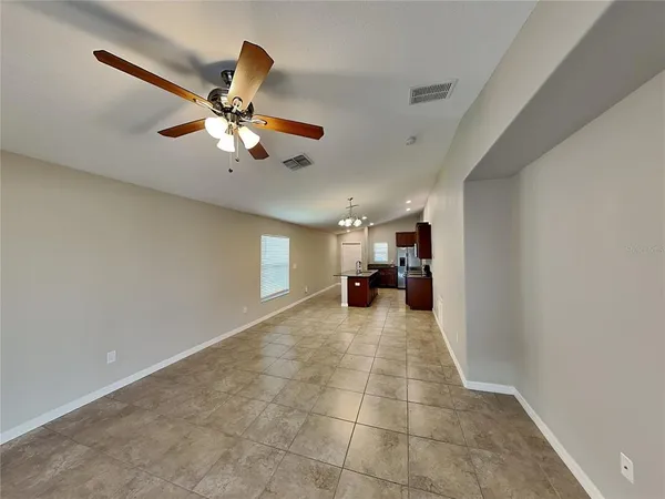 a view of a livingroom with a ceiling fan and window
