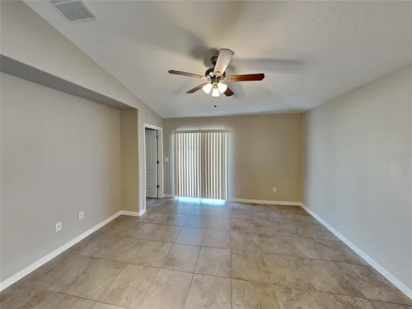 a view of an empty room with a ceiling fan