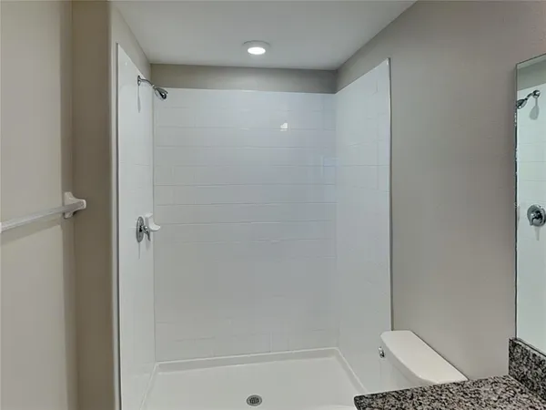 a bathroom with a shower and a toilet