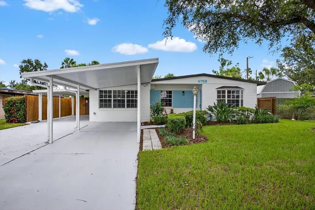 a front view of a house with a yard and porch