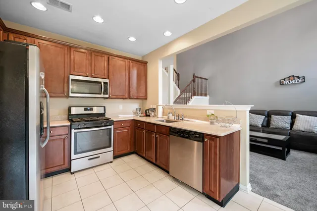 a kitchen with a sink stove and refrigerator