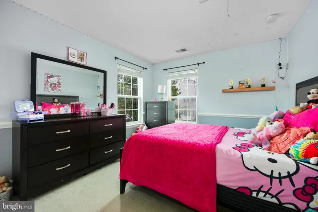 a bedroom with a bed and a dresser