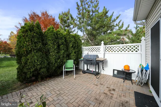 a garden with a bench and some trees