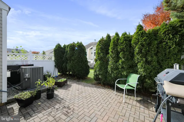 a view of a patio with table and chairs and potted plants