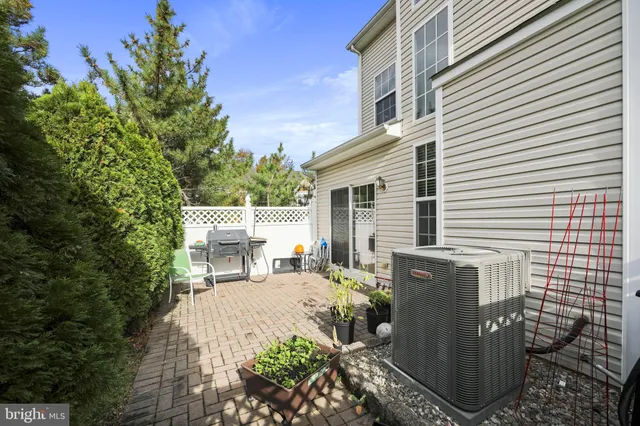 a view of a patio with table and chairs and potted plants
