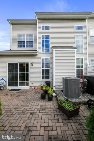a view of a house with porch and garden