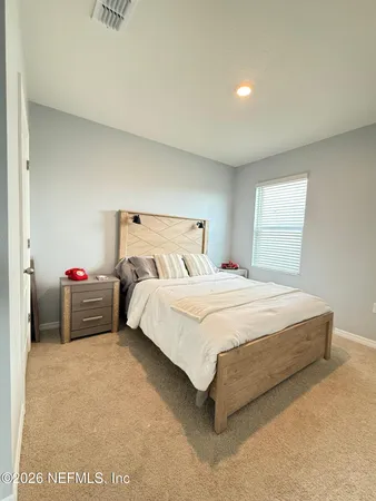 a bedroom with a bed and a closet