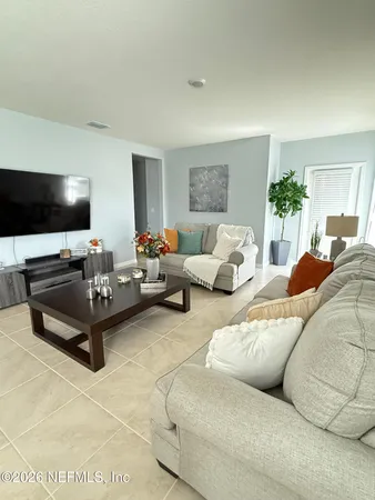 a living room with furniture and a flat screen tv
