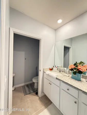 a spacious bathroom with a sink and a mirror