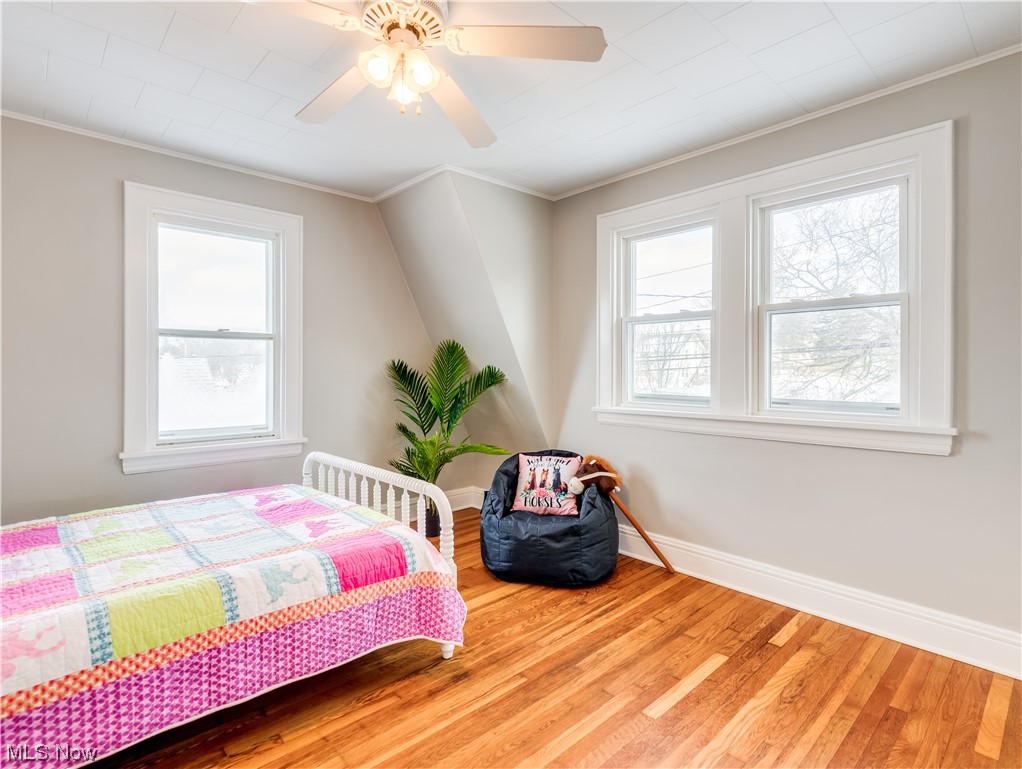 672 Brittain Road Akron, OH 44305 - Photo 18 of 24 Bedroom featuring ornamental molding, light hardwood / wood-style flooring, and ceiling fan