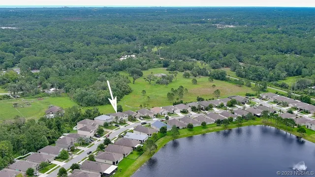 an aerial view of a houses with outdoor space and lake view