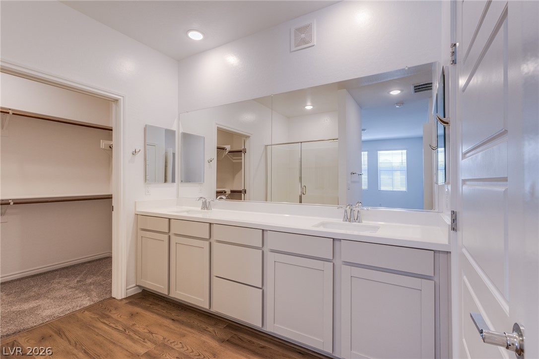 2555 Hampton Road, Unit 8206 Henderson, NV 89052 - Photo 19 of 25 Double vanities and a spacious walk-in closet create a functional and appealing primary bathroom.