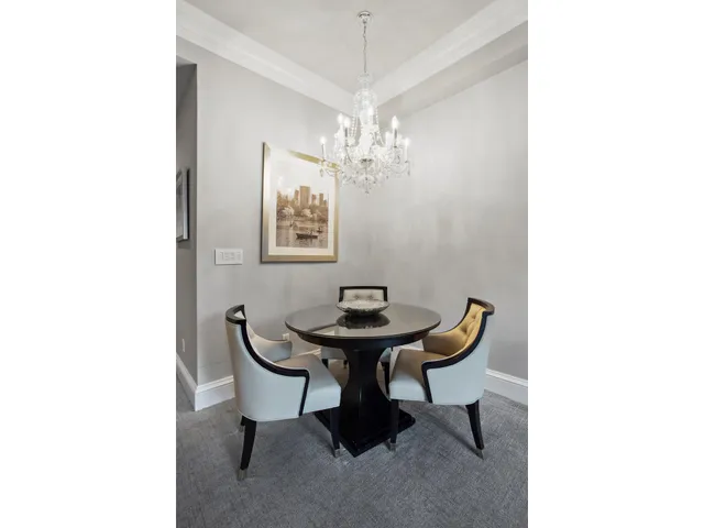 a bedroom with a bed and large windows