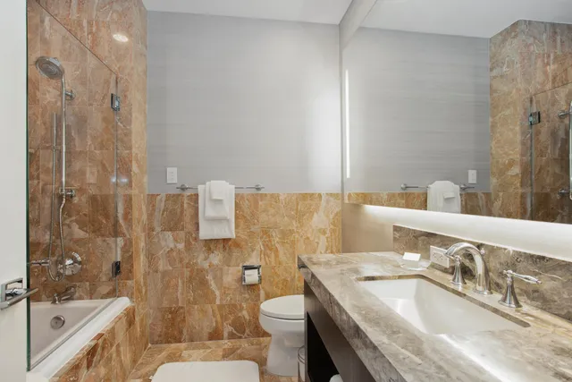 a kitchen with stainless steel appliances granite countertop a stove and a microwave