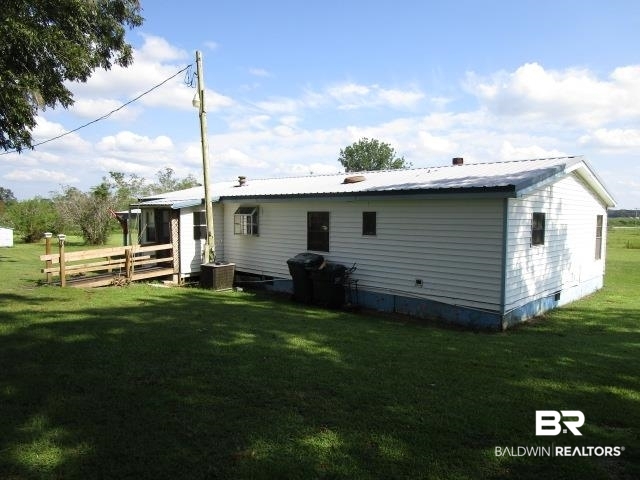20705 Greek Cemetery Road Robertsdale, AL 36567 - Photo 3 of 25 Back of house featuring a metal roof, a yard, and a deck