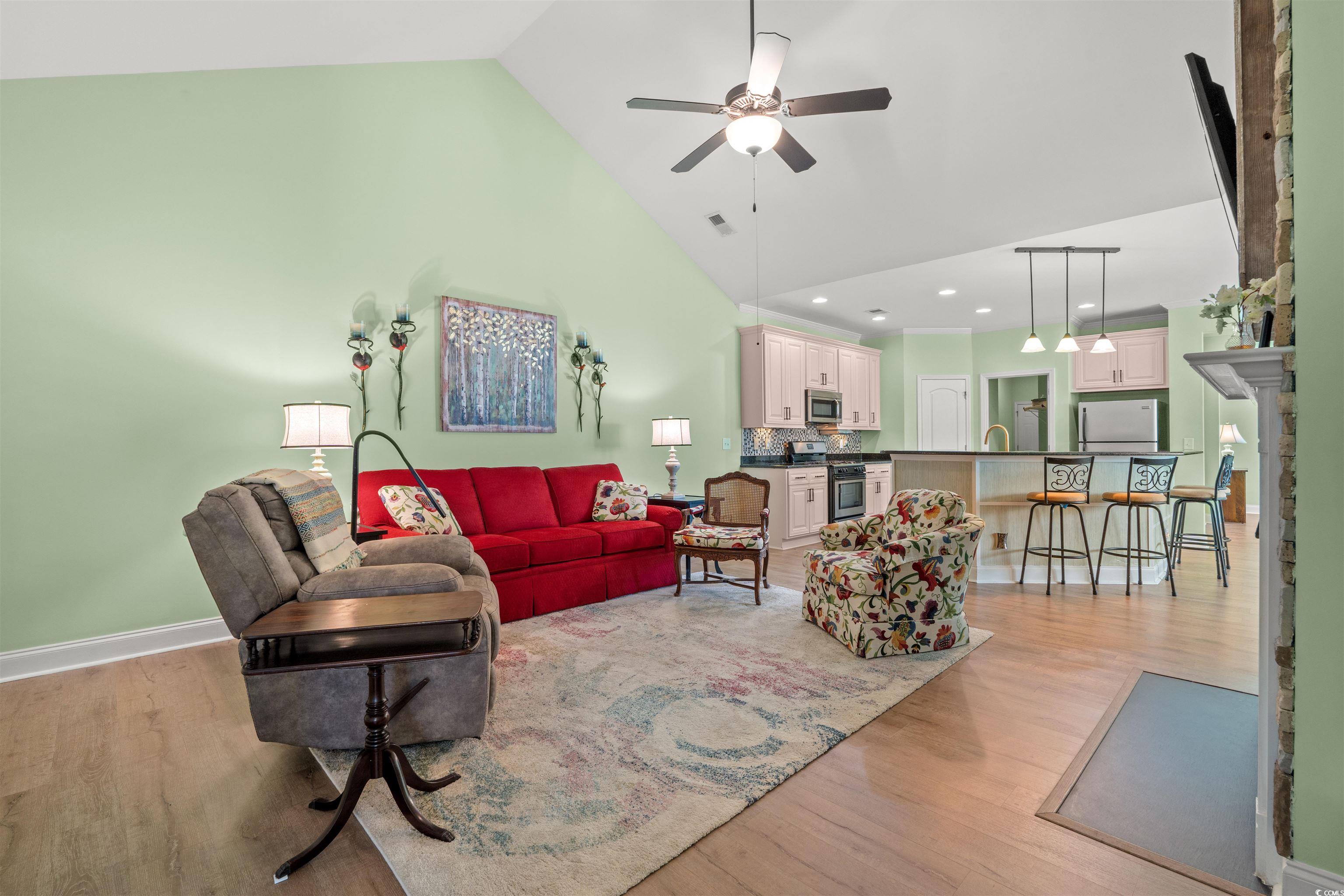 570 Botany Loop, Unit 570 Murrells Inlet, SC 29576 - Photo 13 of 36 Living room with high vaulted ceiling, baseboards, light wood-style floors, visible vents, and ceiling fan