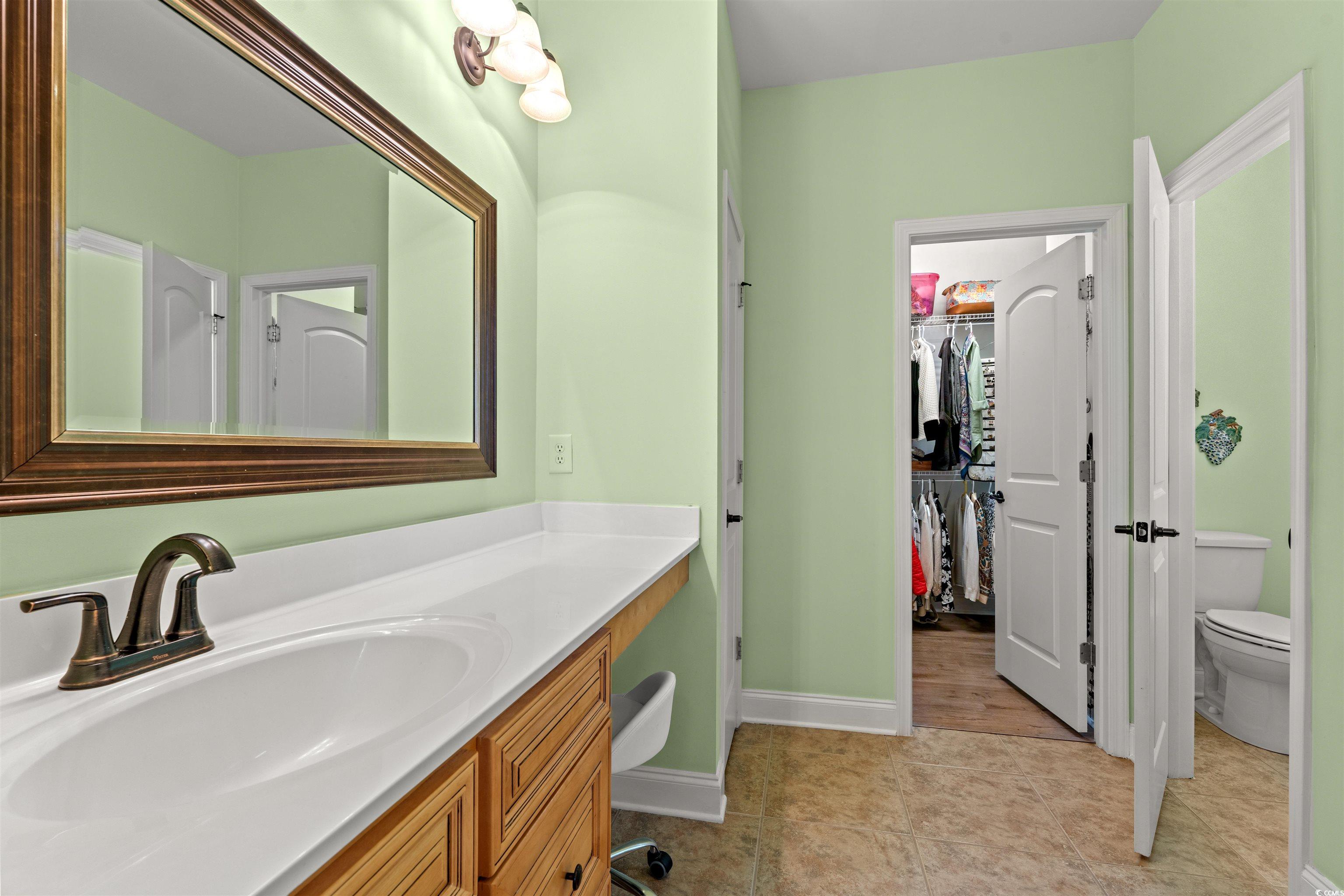 570 Botany Loop, Unit 570 Murrells Inlet, SC 29576 - Photo 21 of 36 Bathroom with baseboards, toilet, tile patterned floors, vanity, and a spacious closet