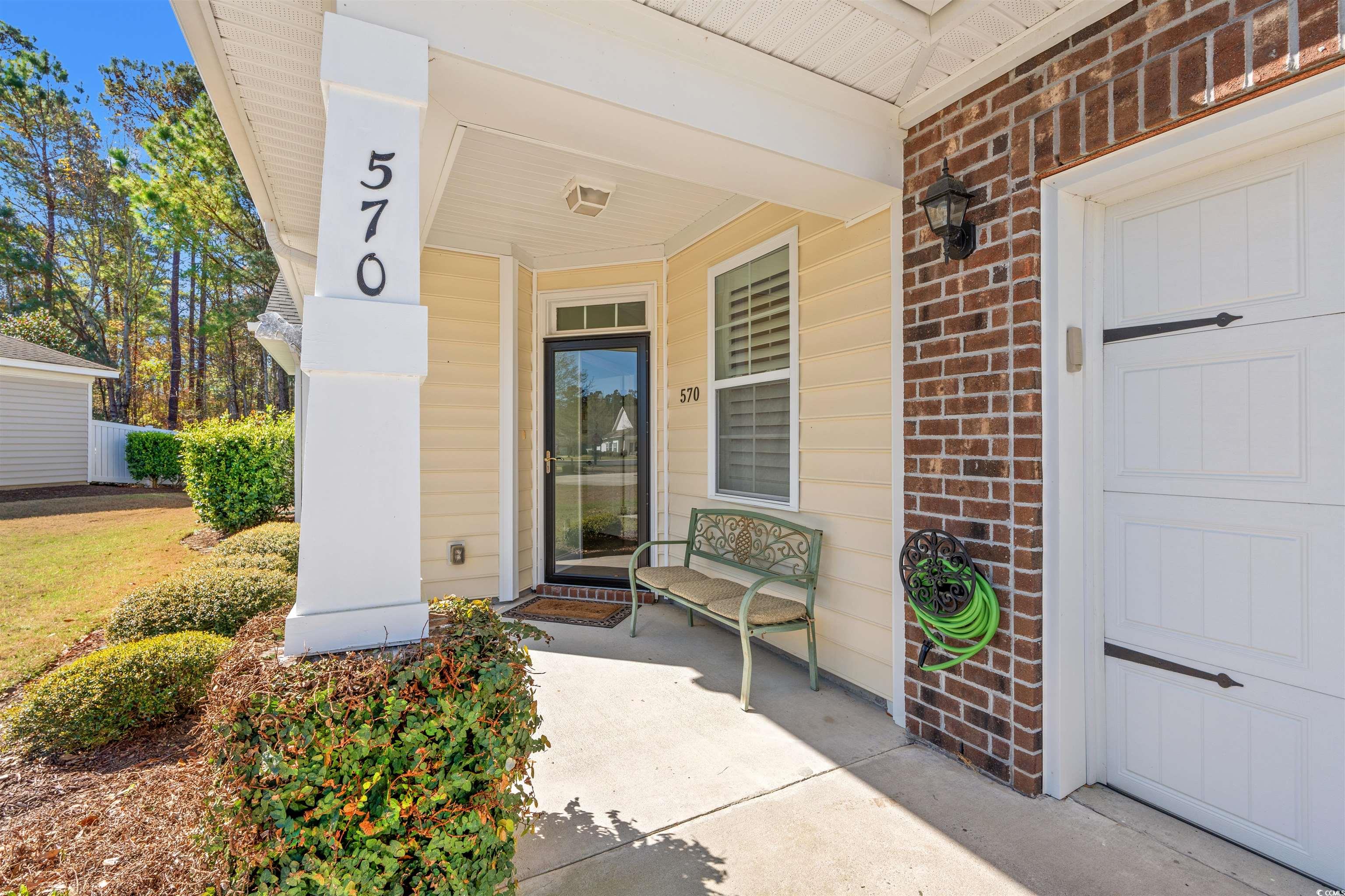 570 Botany Loop, Unit 570 Murrells Inlet, SC 29576 - Photo 3 of 36 Doorway to property with a porch and brick siding