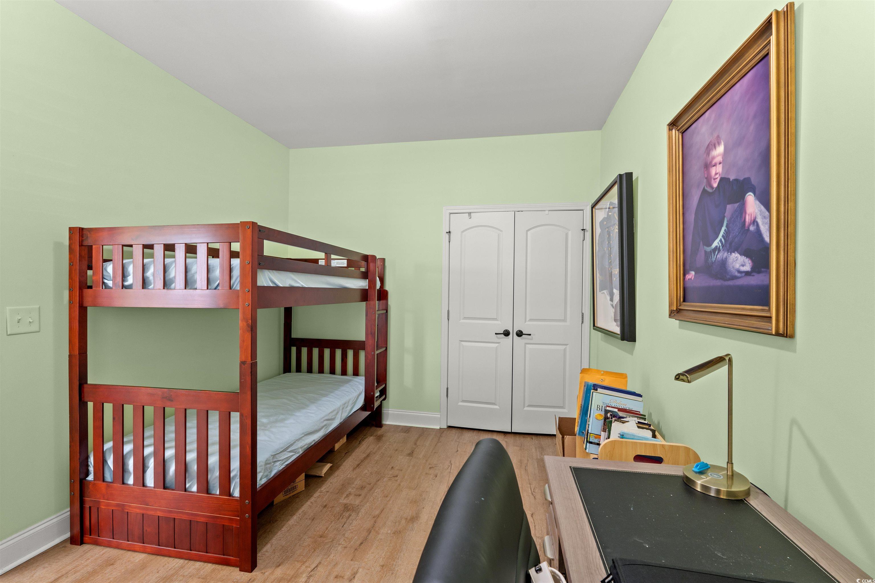 570 Botany Loop, Unit 570 Murrells Inlet, SC 29576 - Photo 7 of 36 Bedroom with a closet, baseboards, and wood finished floors