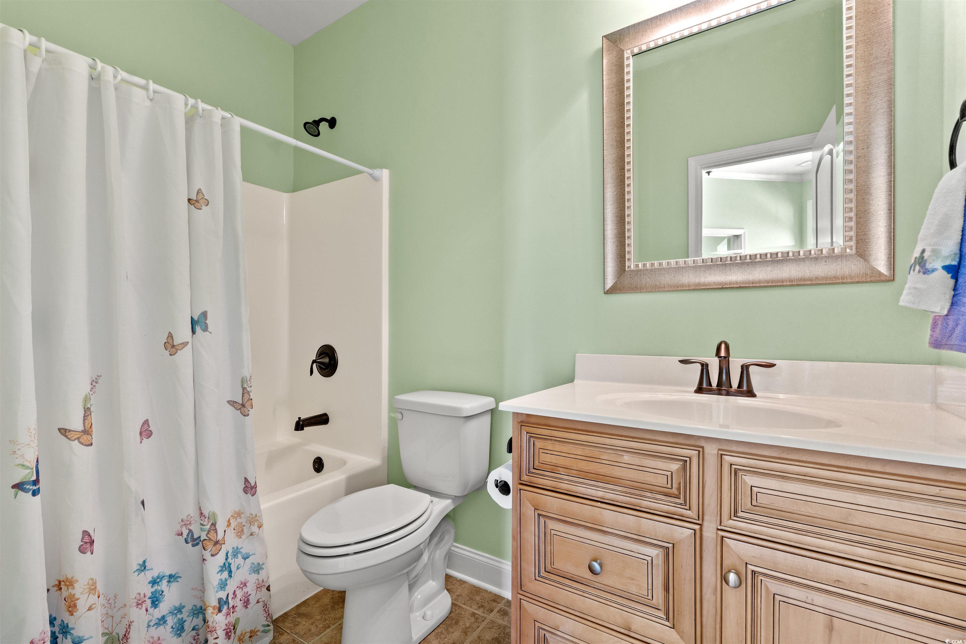 570 Botany Loop, Unit 570 Murrells Inlet, SC 29576 - Photo 8 of 36 Full bath with tile patterned flooring, vanity, shower / tub combo with curtain, toilet, and baseboards