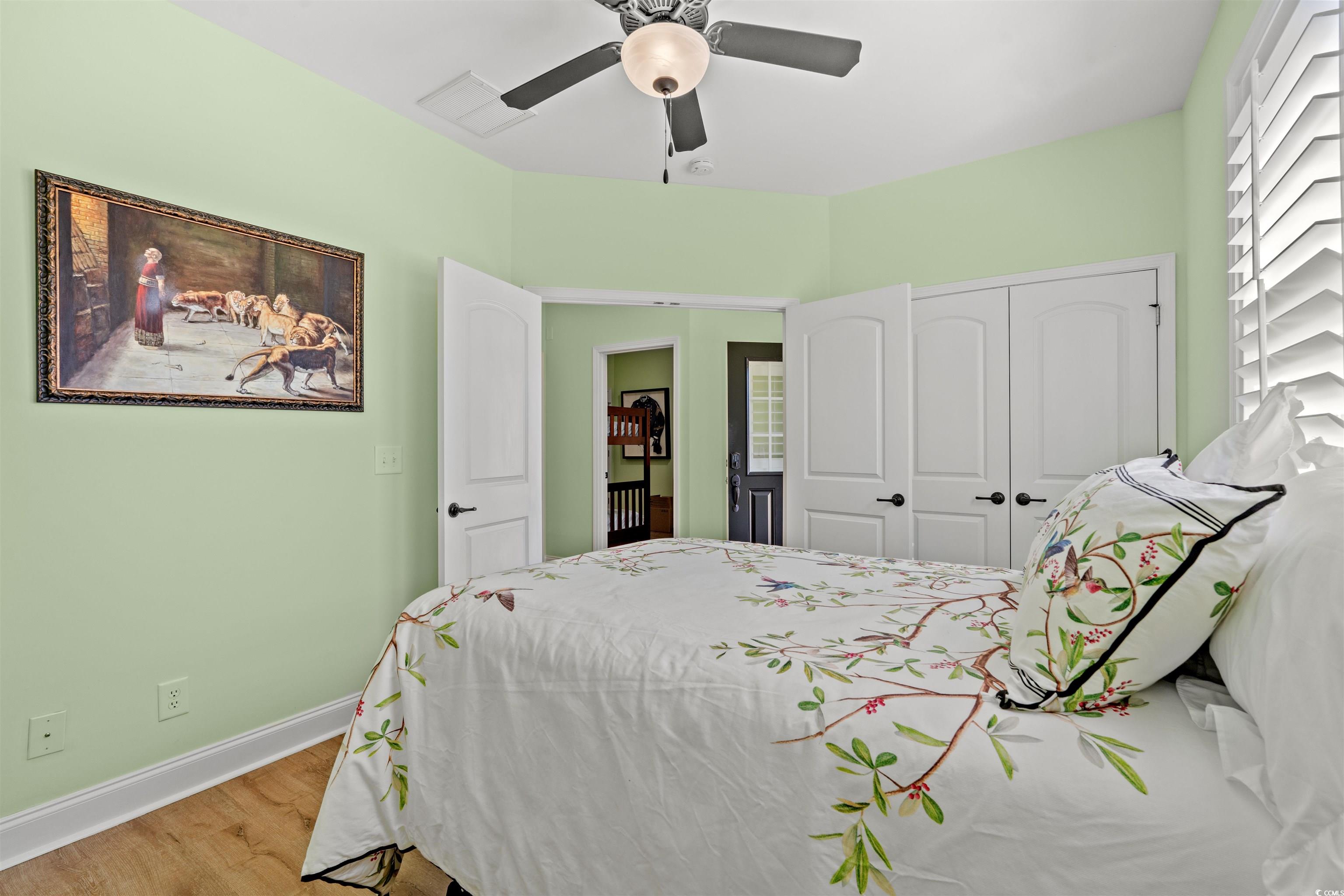 570 Botany Loop, Unit 570 Murrells Inlet, SC 29576 - Photo 9 of 36 Bedroom with baseboards, visible vents, a closet, ceiling fan, and wood finished floors