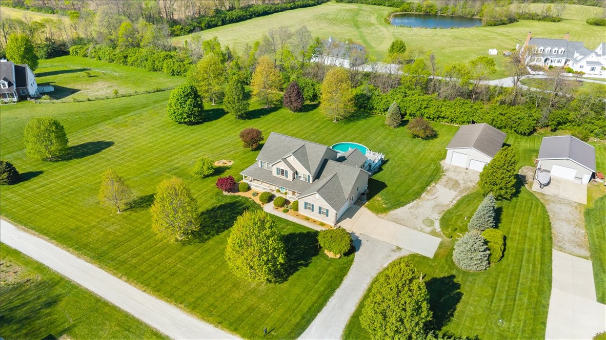 841 Willow Road Springfield, OH 45502 - Photo 63 of 64 An aerial view showcases a spacious property with a private pool and outbuildings, nestled in lush greenery.