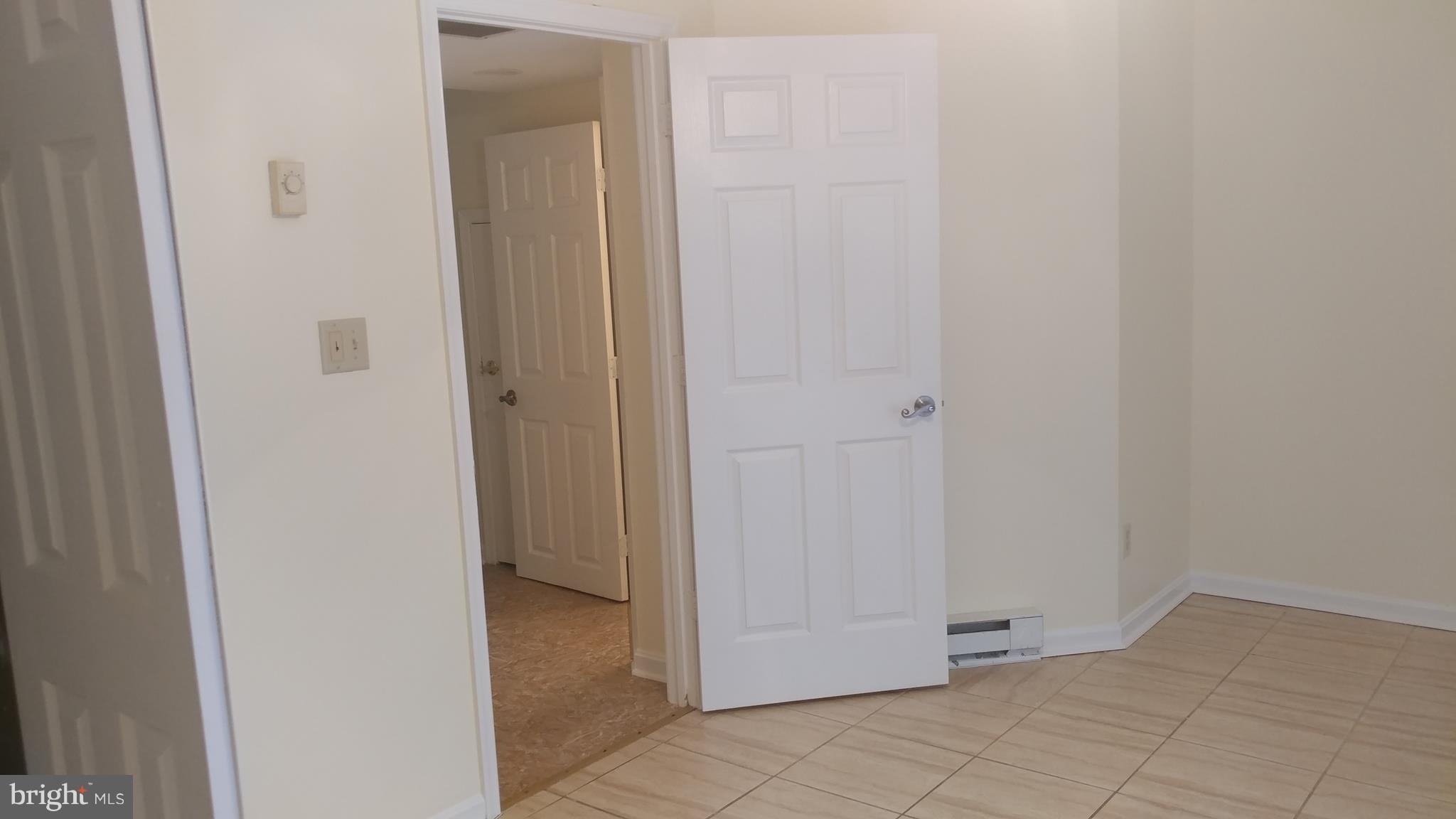 4004 Cutty Sark Road Baltimore, MD 21220 - Photo 21 of 30 Lower Level Family Room/Bedroom with Ceramic Tile