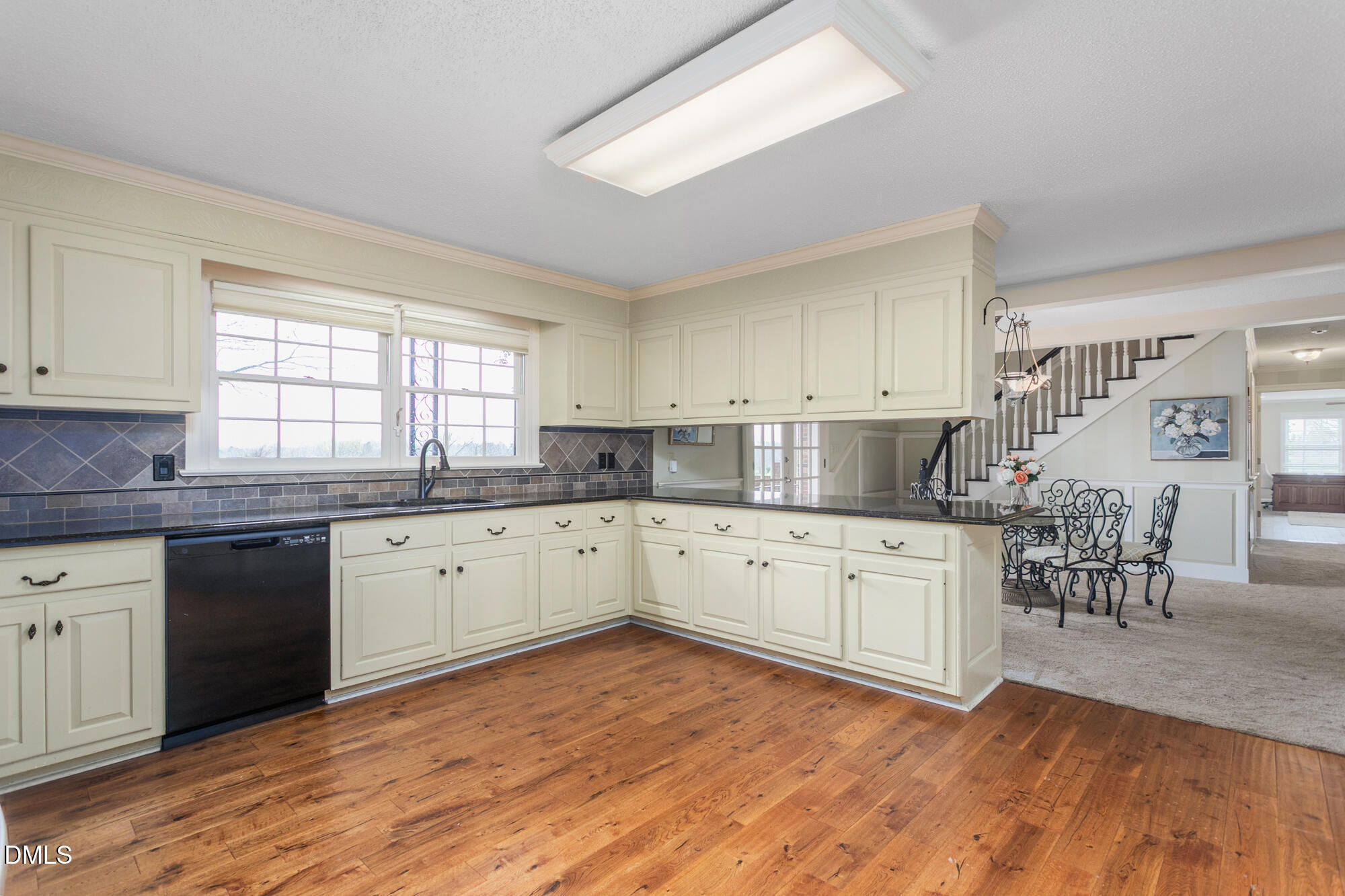 7201 Efland - Cedar Grove Road Cedar Grove, NC 27231 - Photo 12 of 70 a kitchen with granite countertop cabinets a dining table and chairs