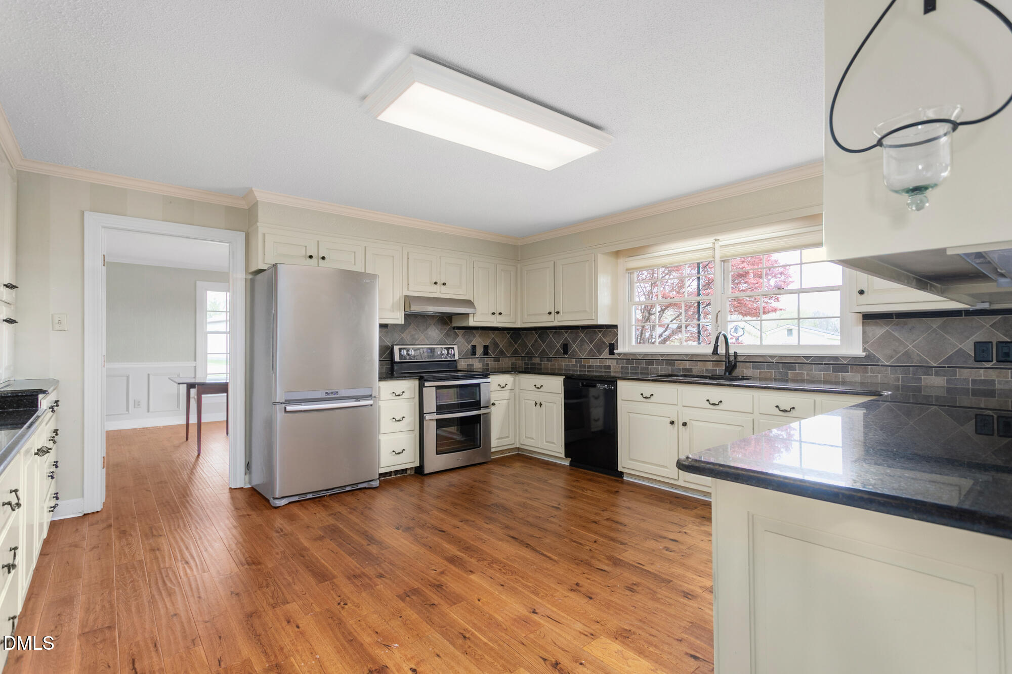 7201 Efland - Cedar Grove Road Cedar Grove, NC 27231 - Photo 14 of 70 a kitchen with granite countertop a refrigerator and a stove top oven