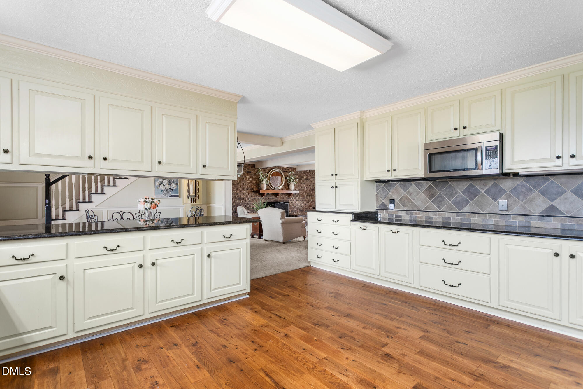 7201 Efland - Cedar Grove Road Cedar Grove, NC 27231 - Photo 15 of 70 a kitchen with granite countertop white cabinets white stainless steel appliances with a sink and dishwasher