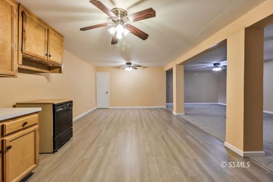 418 North Inyo Street Ridgecrest, CA 93555 - Photo 25 of 35 a view of a kitchen with wooden floor and a ceiling fan