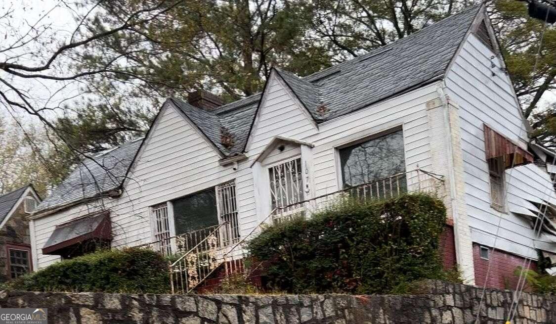 a house that has a tree in front of the house