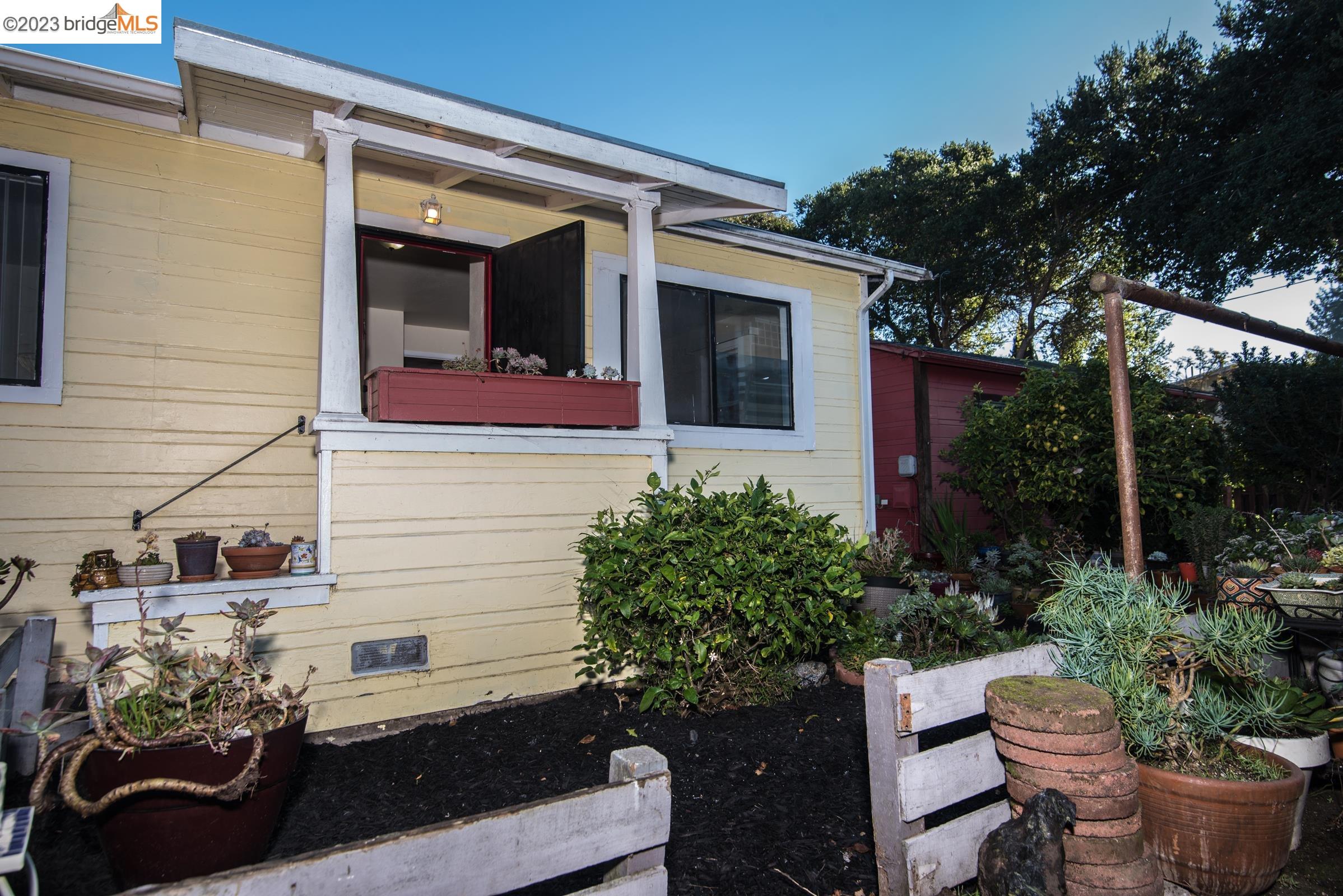 a view of a house with backyard sitting area and garden