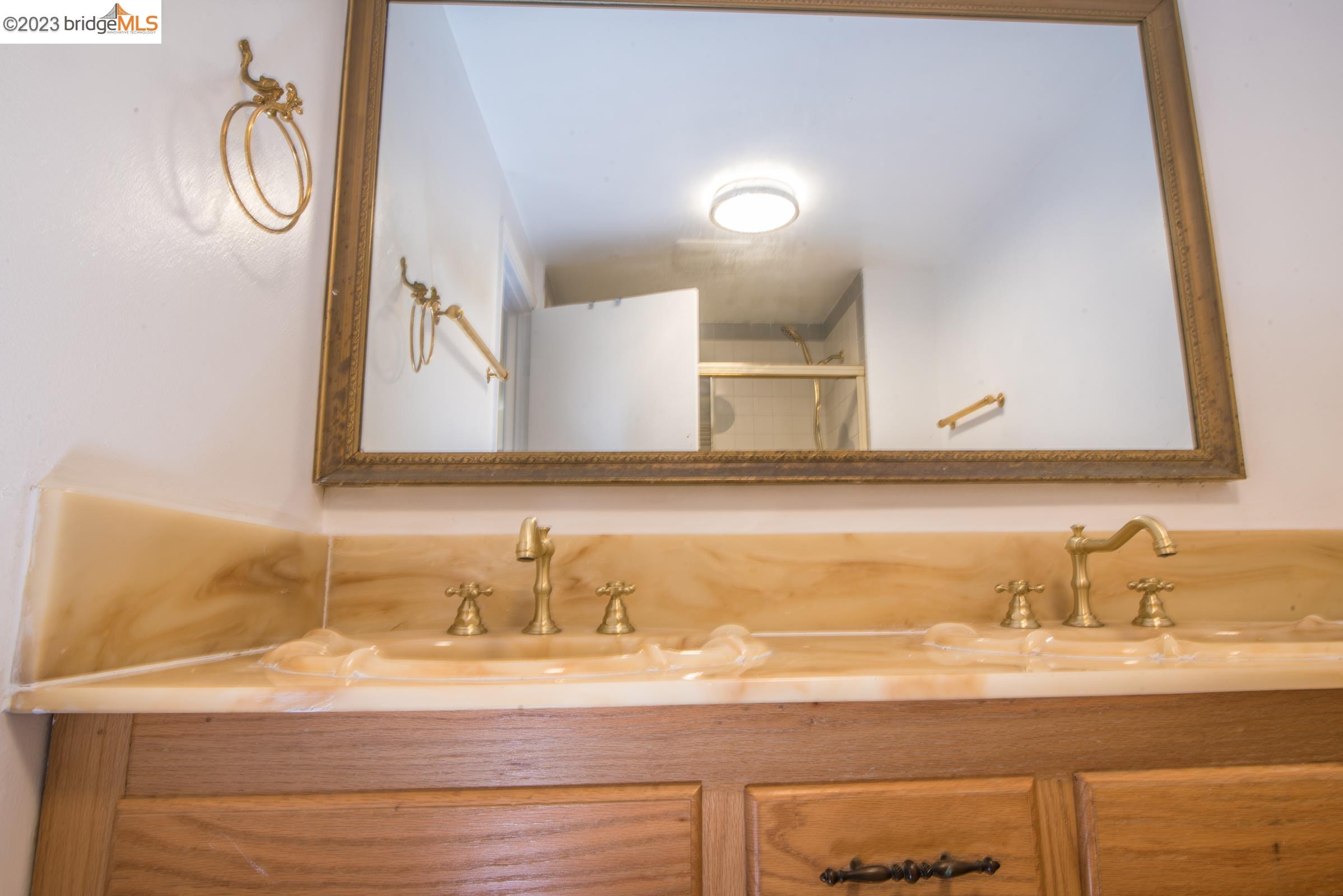 2205 Curtis Street Berkeley, CA 94702 - Photo 18 of 38 a bathroom with a sink and a mirror