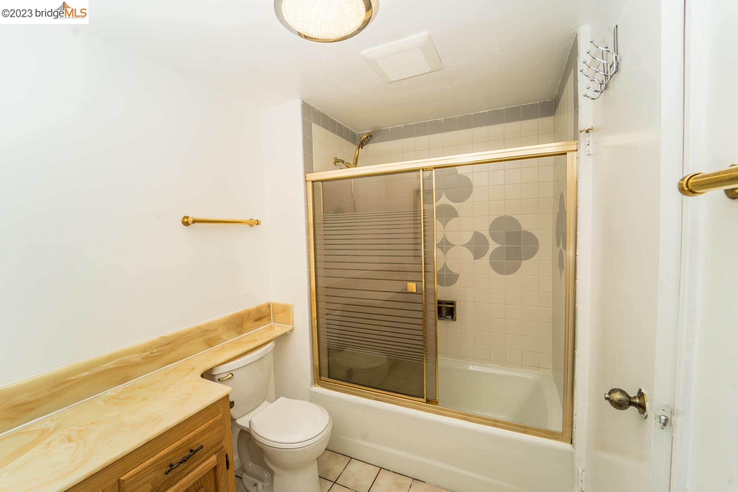2205 Curtis Street Berkeley, CA 94702 - Photo 20 of 38 a bathroom with a shower toilet and sink