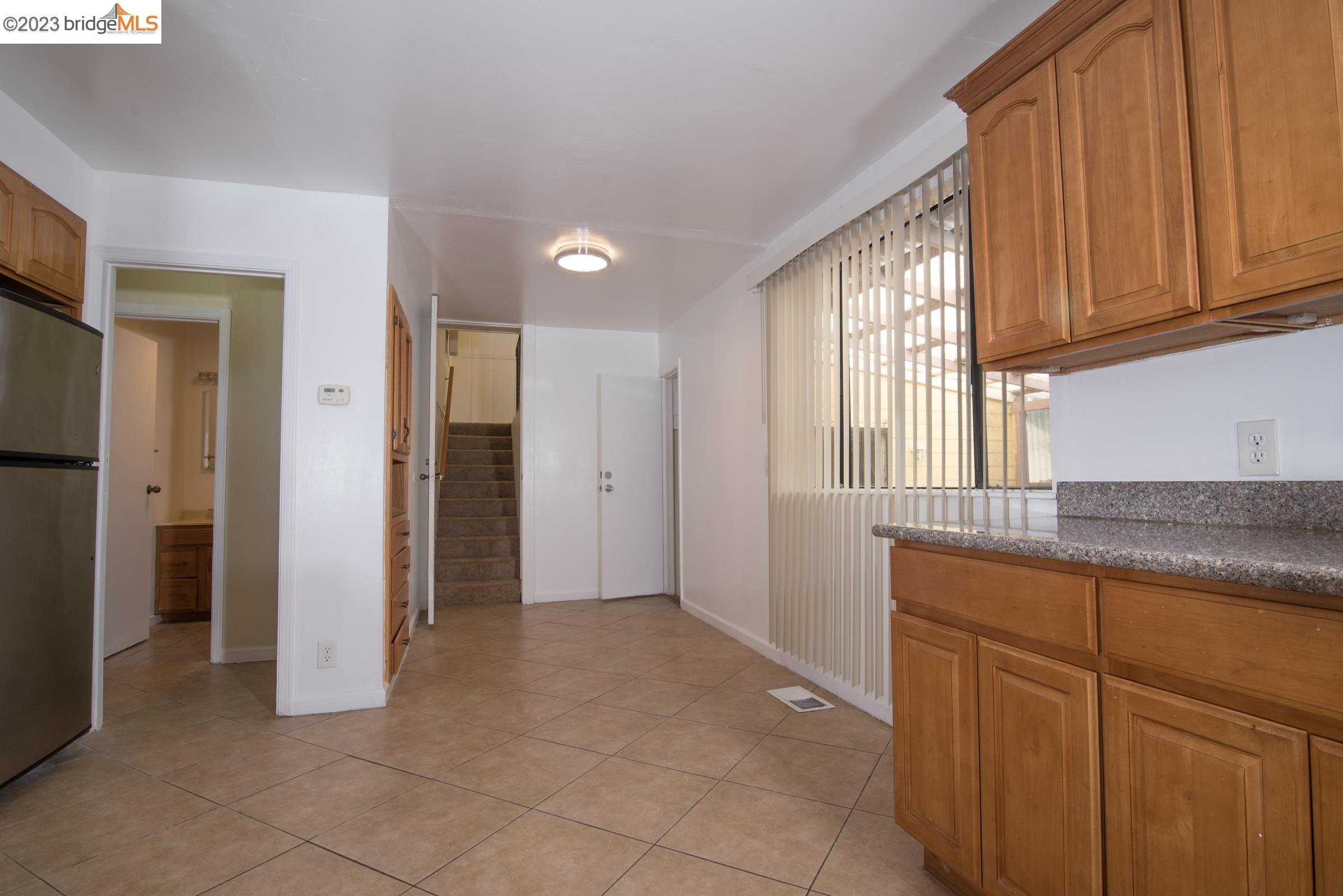 2205 Curtis Street Berkeley, CA 94702 - Photo 27 of 38 a view of kitchen with granite countertop cabinets and refrigerator