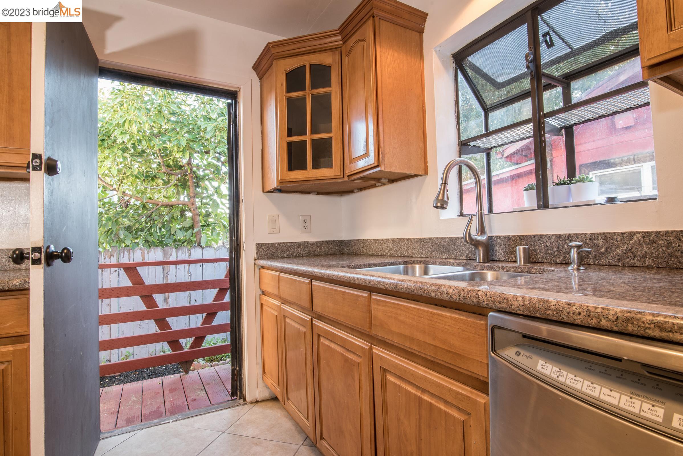 2205 Curtis Street Berkeley, CA 94702 - Photo 34 of 38 a kitchen with stainless steel appliances granite countertop a sink and a window