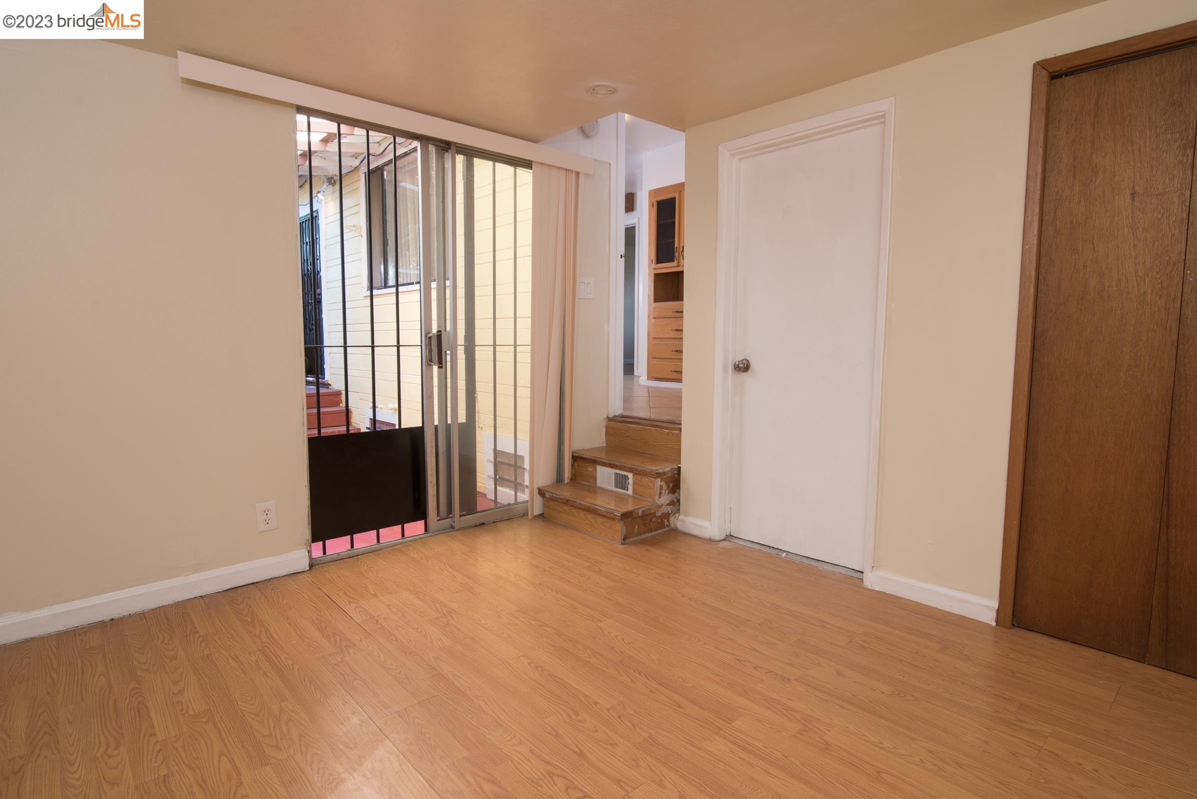 2205 Curtis Street Berkeley, CA 94702 - Photo 10 of 38 wooden floor and window in an empty room