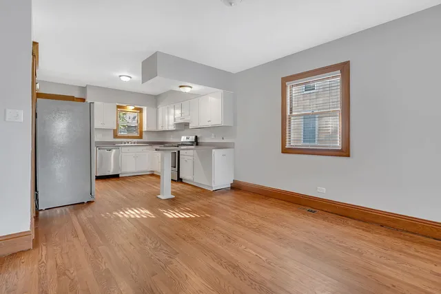 a view of a kitchen with a sink a refrigerator and window
