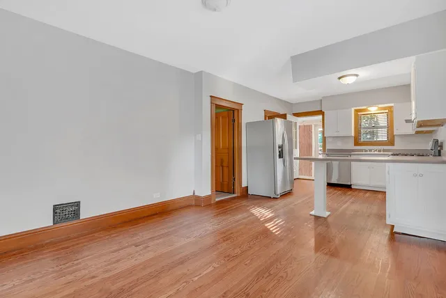 a view of a kitchen with wooden floor and windows