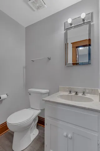 a bathroom with a sink a toilet and mirror