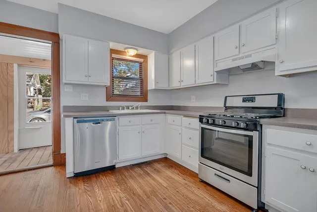 a kitchen with granite countertop a stove and a sink