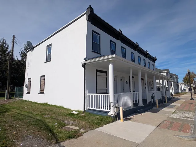 a view of a house with a small yard