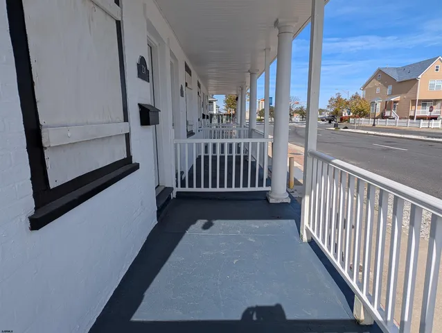 a view of a porch with wooden floor