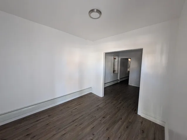 a view of a room with wooden floor and a sink