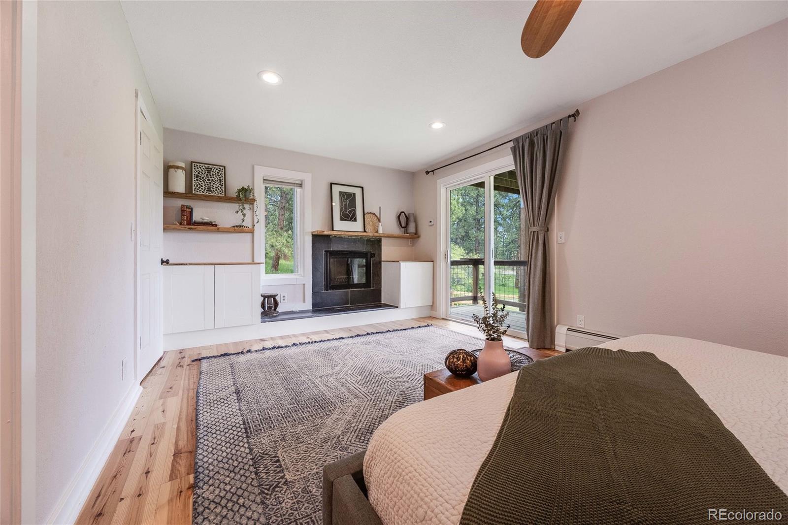 8783 Ault Lane Morrison, CO 80465 - Photo 23 of 40 a living room with furniture and a fireplace